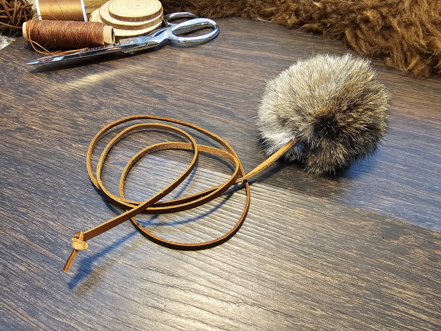 All natural, Rabbit fur Ball on a Durable Leather Cord. Catnip optional.